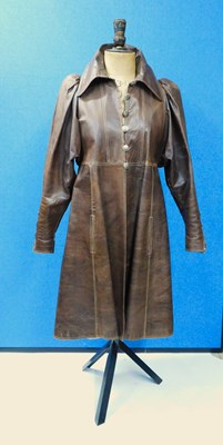 Lot 121 - A brown leather coat by Bill Gibb, with round...