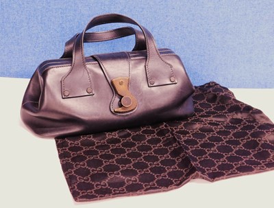 Lot 241 - A black leather Gucci handbag with wooden hook...