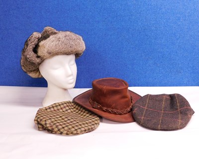 Lot 197 - Four hats to include a tan leather hat by...
