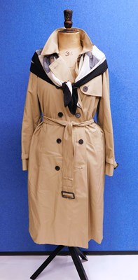 Lot 154 - A beige Aquascutum trench coat, double...