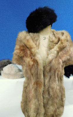 Lot 182 - A tailored fur wrap together with three fur...