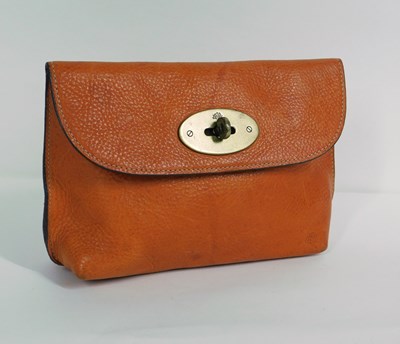 Lot 254 - An orange Mulberry purse, with flap and brass...