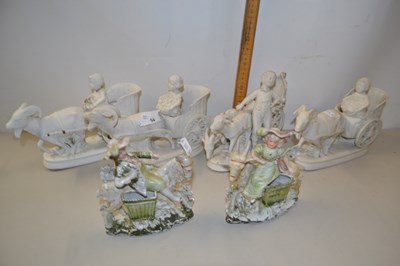 Lot 54 - A set of four bisque porcelain vases formed as...