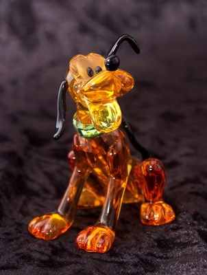 Lot 2 - A Swarovski Disney figure of Pluto with yellow...