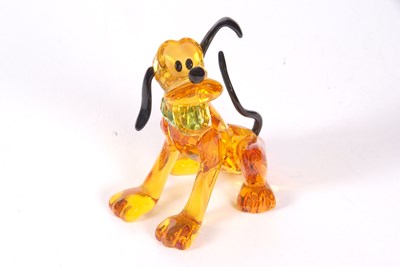 Lot 2 - A Swarovski Disney figure of Pluto with yellow...