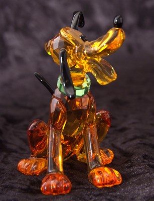 Lot 2 - A Swarovski Disney figure of Pluto with yellow...