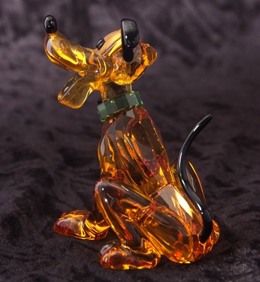 Lot 2 - A Swarovski Disney figure of Pluto with yellow...