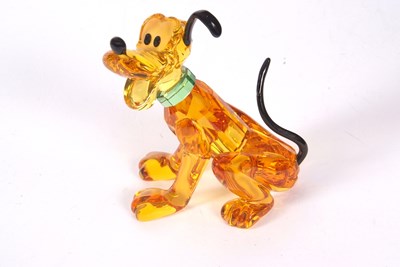 Lot 2 - A Swarovski Disney figure of Pluto with yellow...