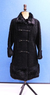 Lot 167 - A black astrakhan coat by Astra Furs, Paris,...