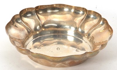 Lot 21 - A sterling silver dish with scallop rim border,...
