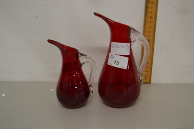 Lot 73 - Two red glass jugs