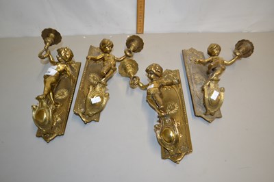 Lot 139 - Group of four brass wall mounted figural table...