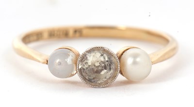 Lot 20 - An 18ct three stone ring, set with a central...