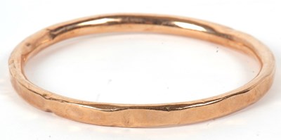Lot 36 - A 9ct gold bangle, the round hollow bangle...