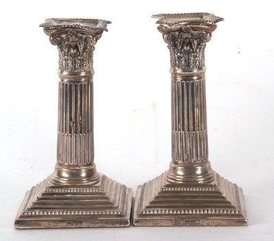 Lot 36 - A pair of late Victorian silver candlesticks...