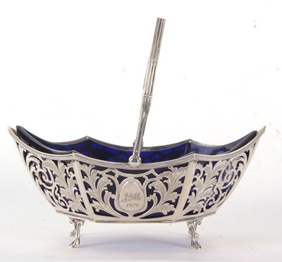 Lot 66 - An Edwardian silver pierced swing handle sugar...