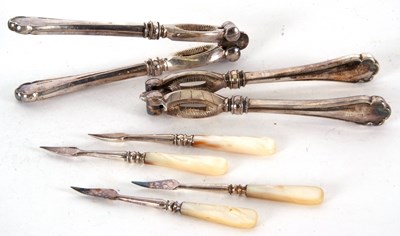 Lot 74 - A  cased set two pairs of silver plated nut...