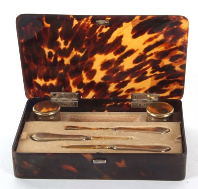 Lot 143 - A George V silver manicure set in a...