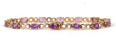 Lot 73 - A 9ct amethyst and diamond bracelet, the oval...