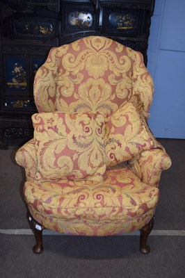Lot 596 - A Georgian style walnut framed wing back...