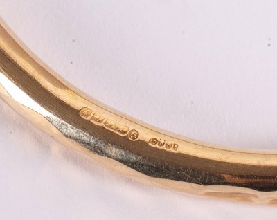 Lot 84 - A 9ct upper arm bangle, the hollow bangle...