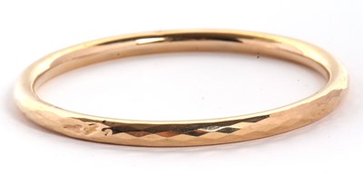 Lot 84 - A 9ct upper arm bangle, the hollow bangle...