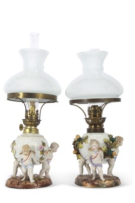Lot 13 - A pair of continental porcelain lamps with...