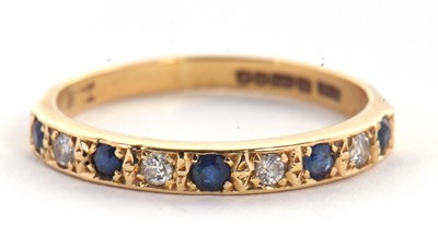 Lot 56 - An 18ct sapphire and diamond ring, the half...