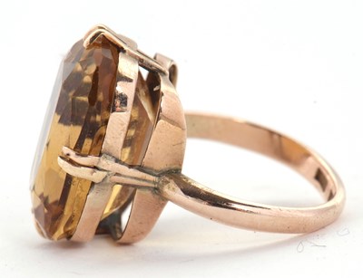Lot 27 - A 9ct citrine ring, the oval mixed cut citrine,...