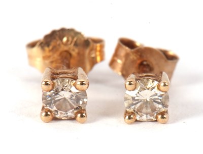 Lot 122 - A pair of 9k diamond studs, the round...
