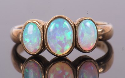 Lot 63 - A 9ct opal ring, the three oval opal cabochons...