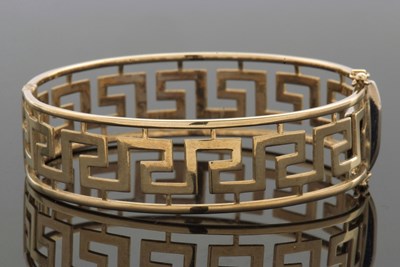 Lot 352 - A 9ct Greek key bangle, the hinged bangle with...