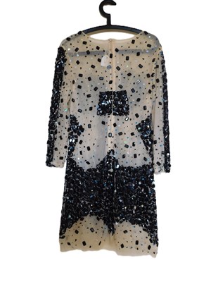 Lot 49 - A black and cream beaded cocktail dress, the...