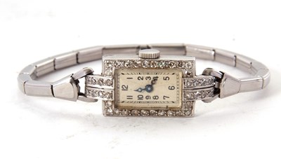 Lot 246 - A precious metal and diamond surrounded...