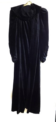 Lot 19 - A black velvet evening gown, the sleeveless...