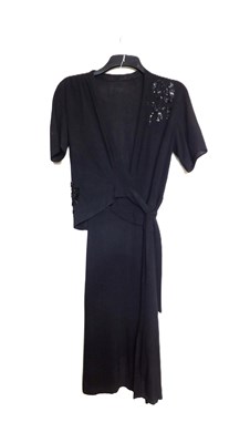 Lot 19 - A black velvet evening gown, the sleeveless...