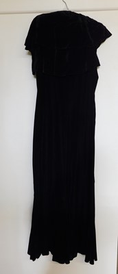 Lot 19 - A black velvet evening gown, the sleeveless...