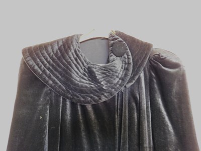 Lot 19 - A black velvet evening gown, the sleeveless...