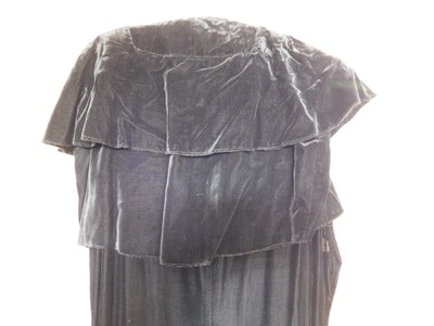 Lot 19 - A black velvet evening gown, the sleeveless...