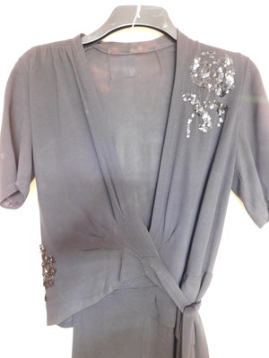 Lot 19 - A black velvet evening gown, the sleeveless...