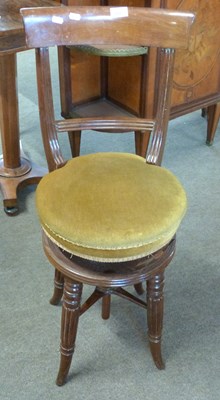 Lot 533 - A Victorian revolving high back music chair on...