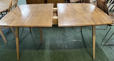 Lot 198 - An Ercol light elm extending dining table...