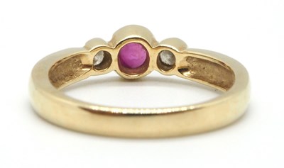 Lot 22 - A 9ct ruby and diamond ring, the round collet...