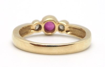 Lot 22 - A 9ct ruby and diamond ring, the round collet...