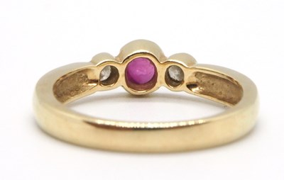 Lot 22 - A 9ct ruby and diamond ring, the round collet...
