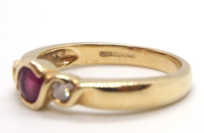 Lot 22 - A 9ct ruby and diamond ring, the round collet...