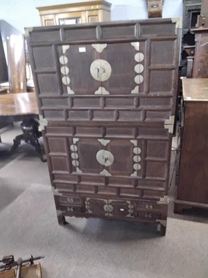Lot 545 - 20th century Chinese elm three-section cabinet...