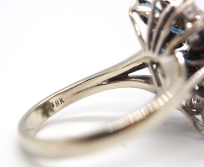 Lot 53 - An 18k sapphire and diamond ring, set with a...