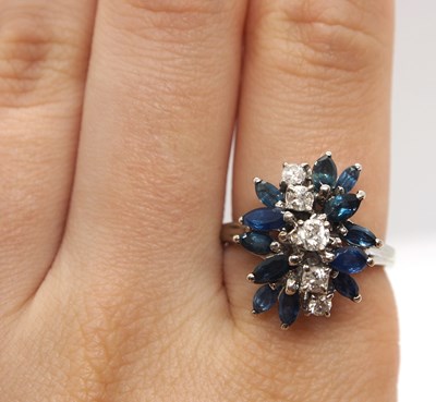 Lot 53 - An 18k sapphire and diamond ring, set with a...