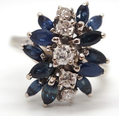 Lot 53 - An 18k sapphire and diamond ring, set with a...